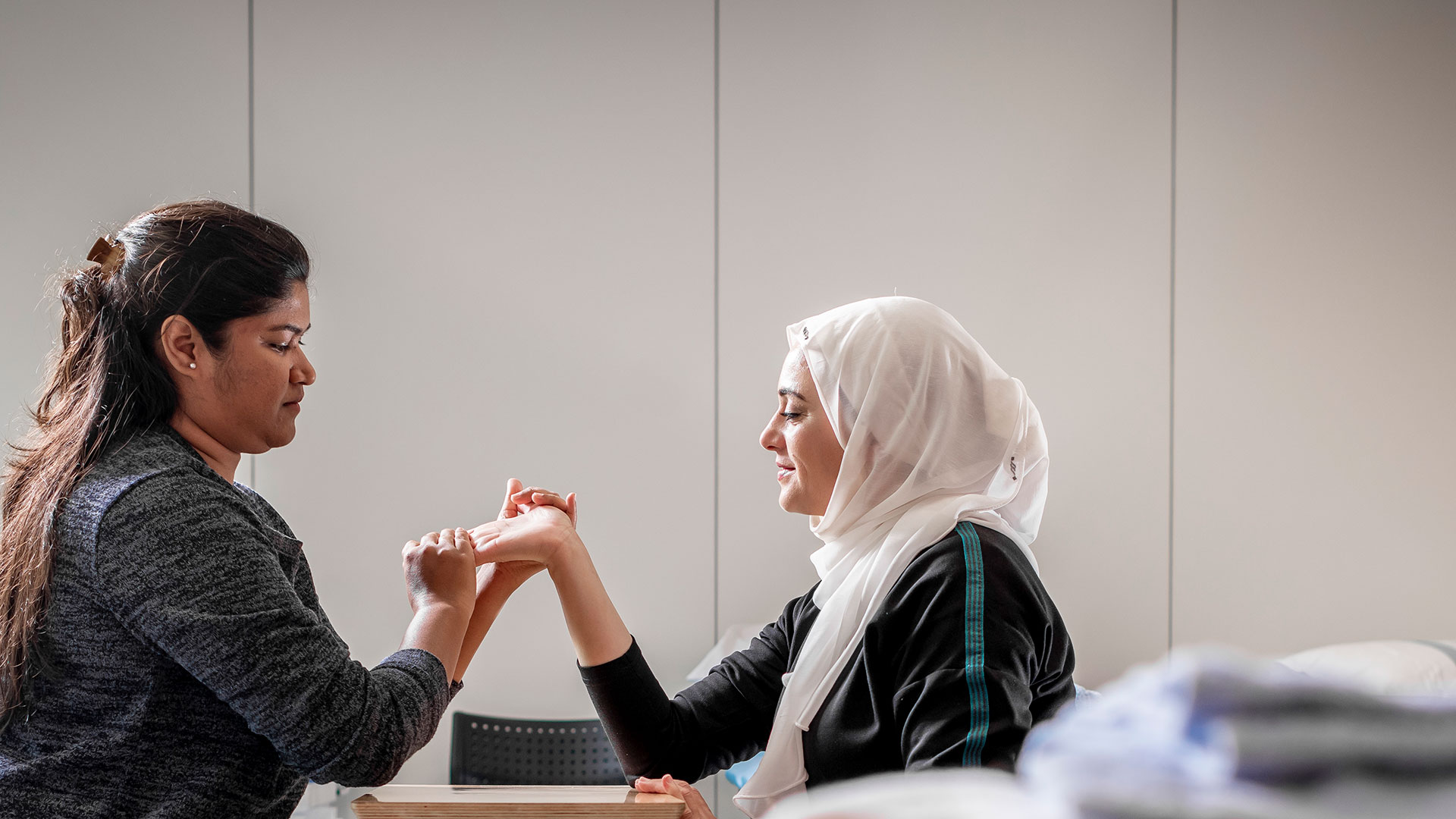 Female doctor examining a females hand 