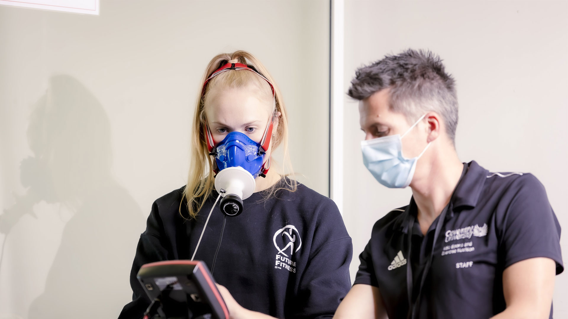 Student using breathing monitor while using an exercise bike