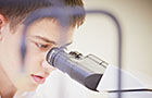 Student using a microscope