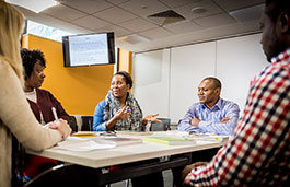 Students debating around a table