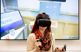 woman wearing  a VR headset and holding remote controls