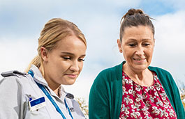 A nurse and a woman looking down