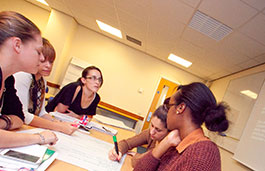 A group of students and a teacher sat around a table