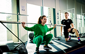 A student lifting weights with a tutors guidance