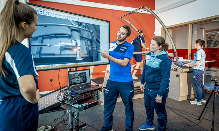 A few students showing their work on a large screen