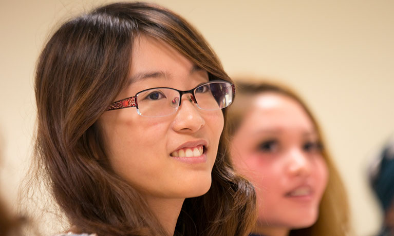 Two female students looking to the right