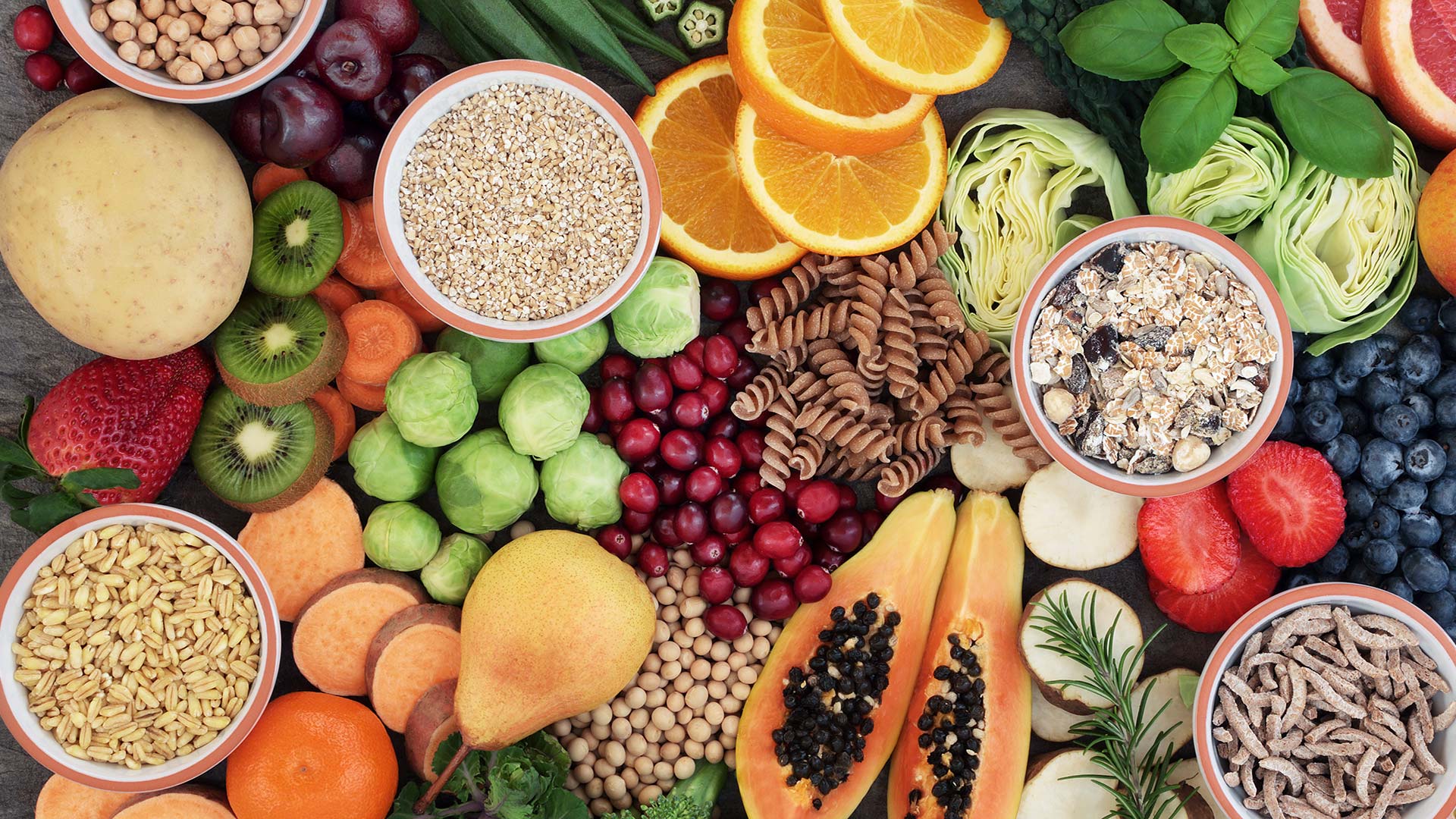 Assortment of sliced fruit on a dark table