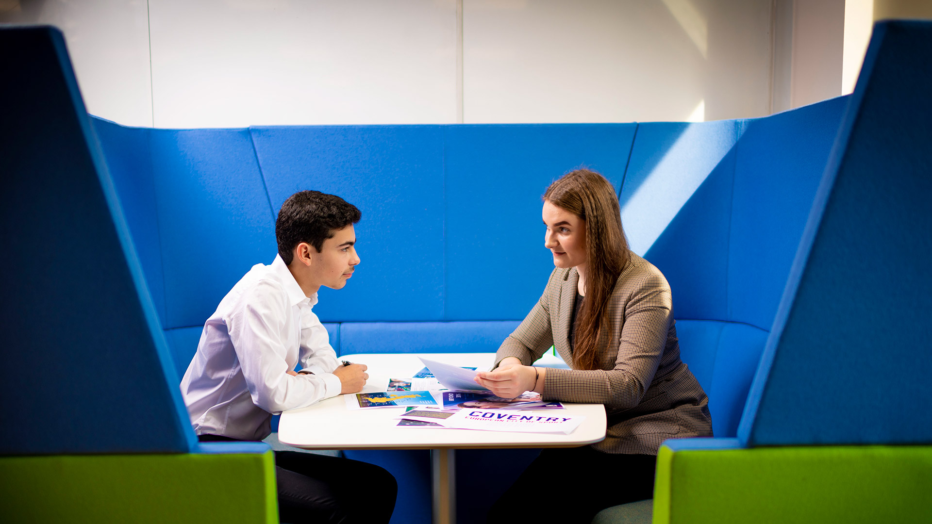 two students working together in a study space