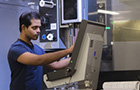 student using engineering lab machinery