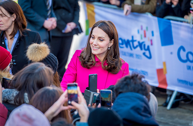 The Duchess of Cambridge smiling and meeting the crowds outside