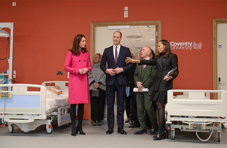 Duke and Duchess of Cambridge being shown the mock hospital ward