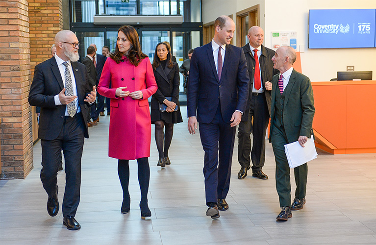 The Duke and Duchess of Cambridge walking through the Health and Life Sciences building with Professor Ian Dunn