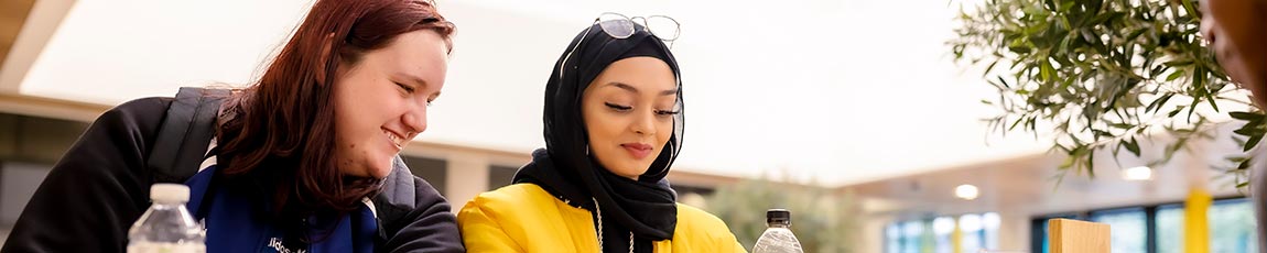 close up of two females chatting outside