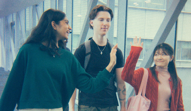 Two students high-fiving in a corridor in the Engineering building
