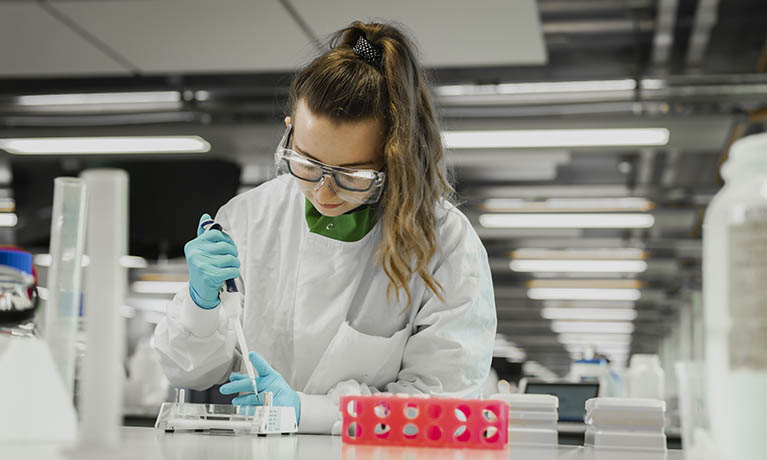 Female student working in lab environment.