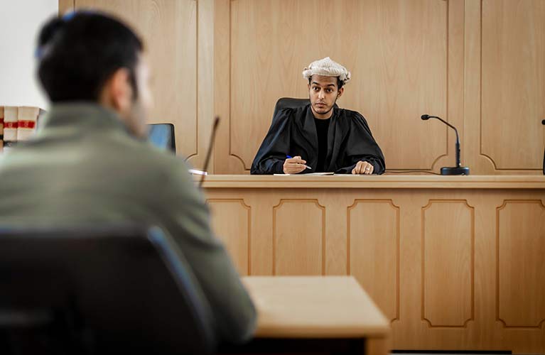 student wearing a wig in a mock court room 