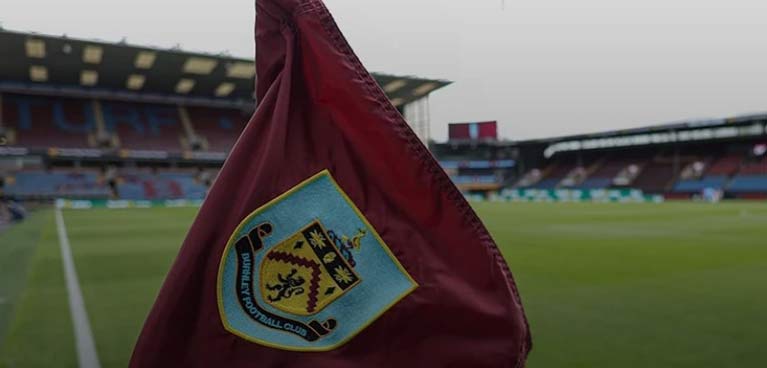 flag with coventry city football club badge with the football pitch in the background