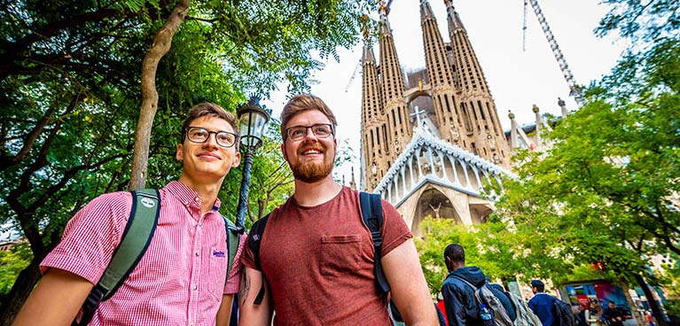 two students on a trip to Barcelona - with the La Sagrada Familia in the background