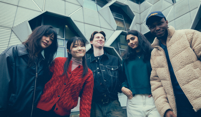 A group of students smiling for the camera outside the Engineering building