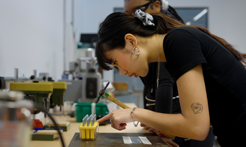 A student using the metal work lab in Delia Derbyshire