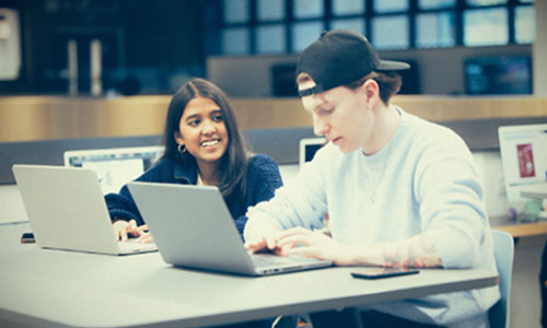 Two students sat working together