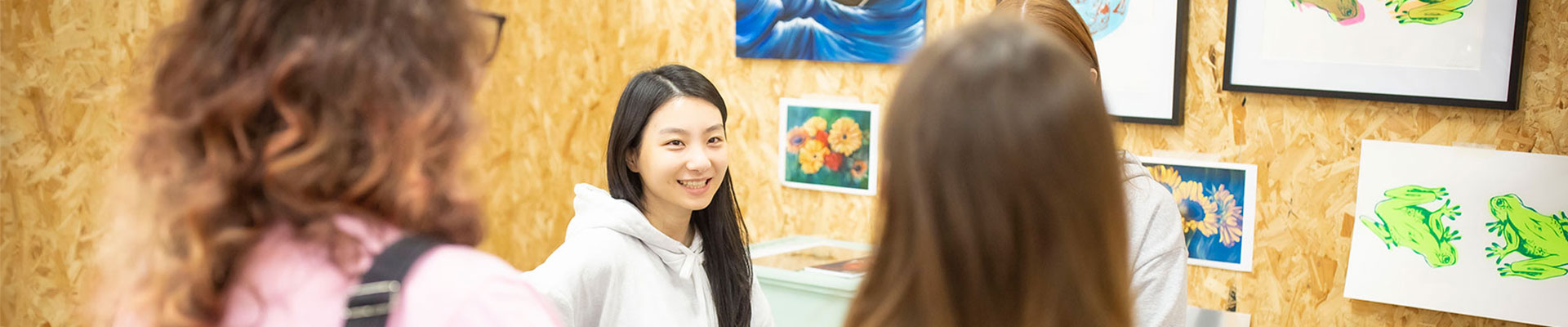 Students looking at a wall of art