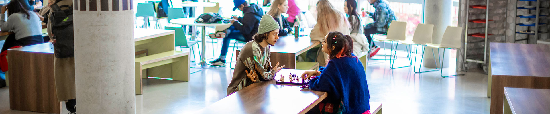 Students playing chess in the hub.