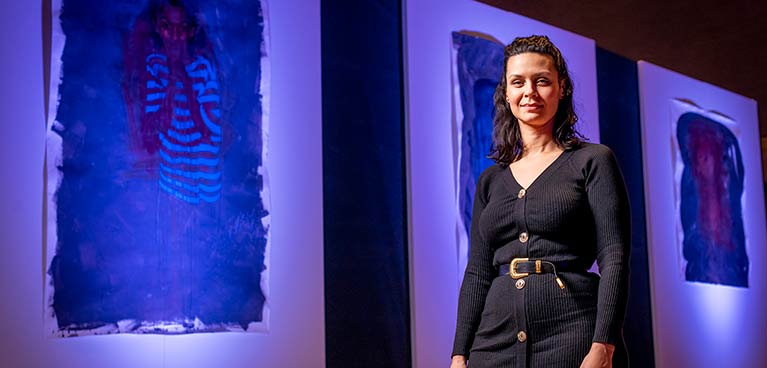 Woman stood against artwork