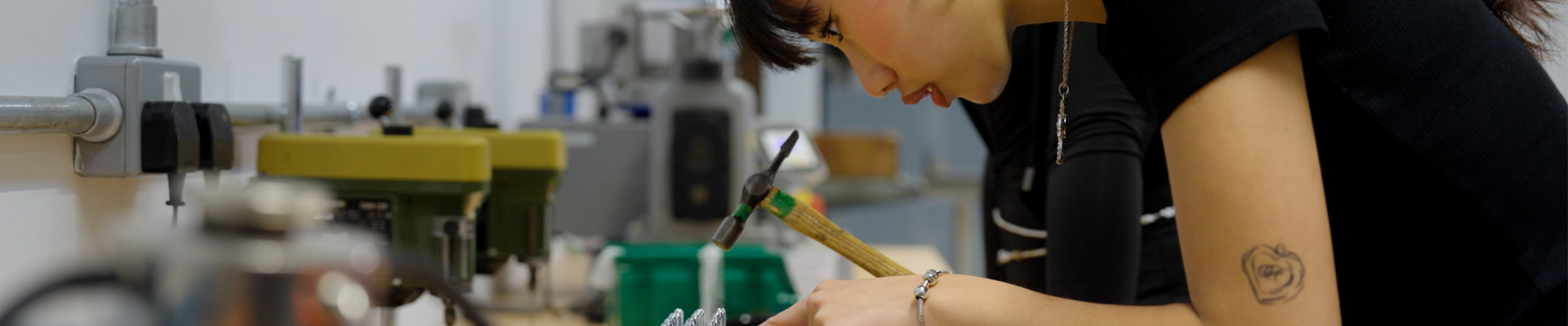 A student making jewellery in the metalwork lab.