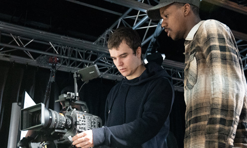 Two students using a camera in the film studio.