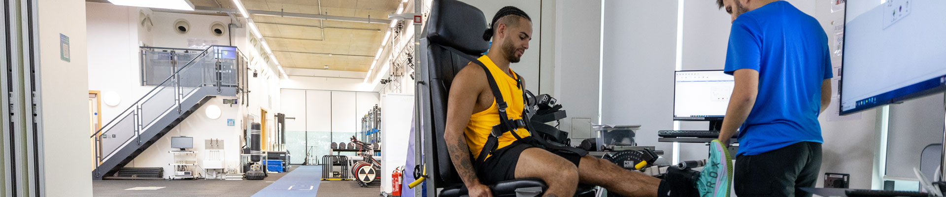 A person in sportswear using an isokinetic dynamometer for a strength and muscle function assessment