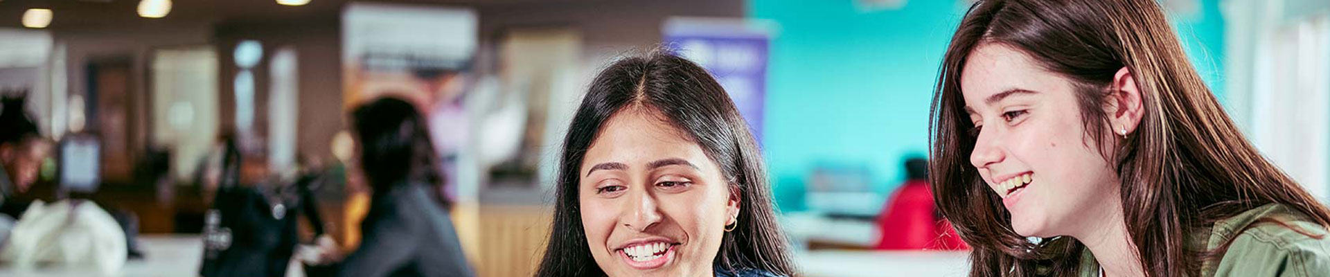two women sat together at a computer