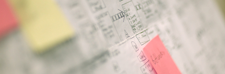 A postit note on an illustrated board.