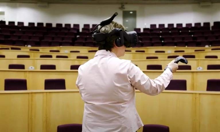 lecturer wearing headset in empty theatre