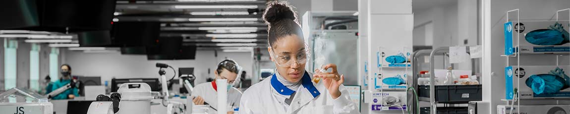 laboratory student scientist looking at a test tube