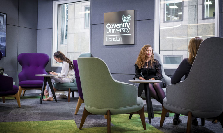 two women talking in a university social space