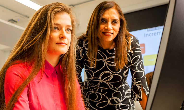 Student with a lecturer looking at a monitor