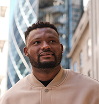 BAME male student with London buildings in the background