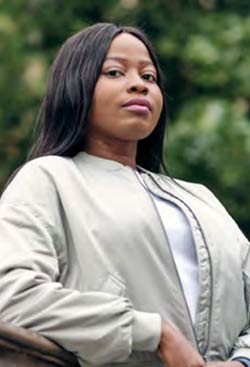 student in a park leaning against a bridge front cover of PG prospectus 22/23