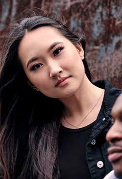 Young student bending her head to the side in relaxed pose 2022 UG Prospectus Cover