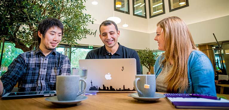 Three students sat talking