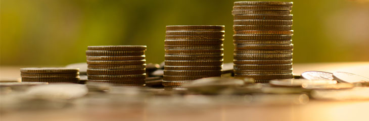 Pound coins stacked in piles