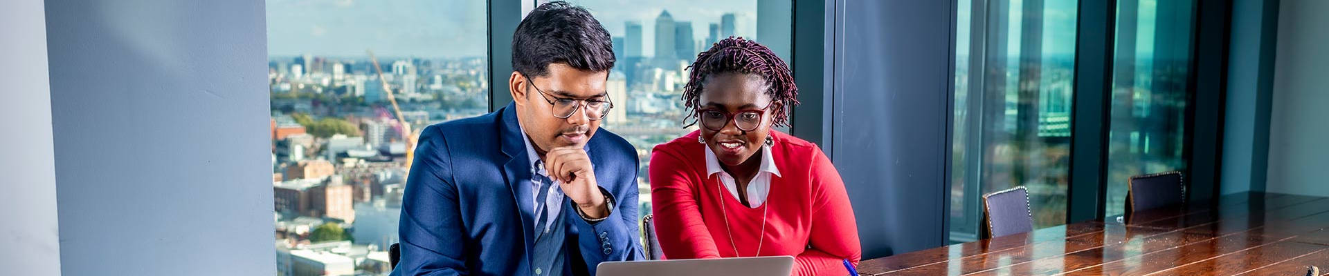 Man and woman looking at a laptop