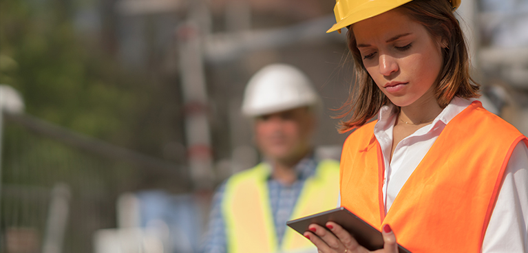 Construction worker looking at tablet