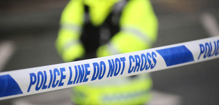 police tape with police officer in fluorescent jacket