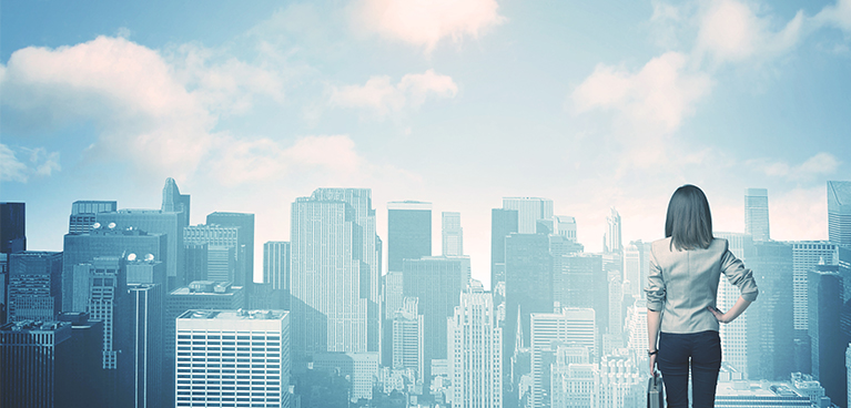 stock photo of a woman facing a city skyline