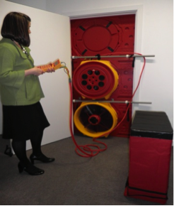 A woman using a Multiple Fan Blower Door System