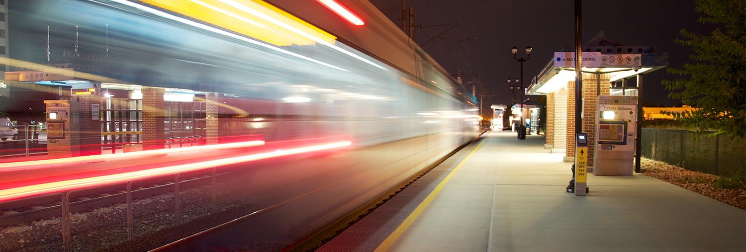 Blurred train moving through station at night