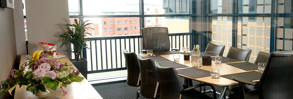 One of our conference rooms, showing a large meeting table seating 8 chairs