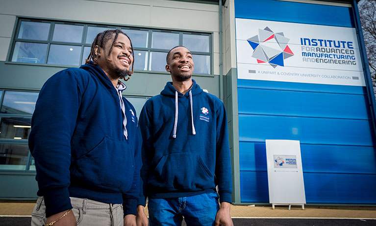 Two students outside the AME building